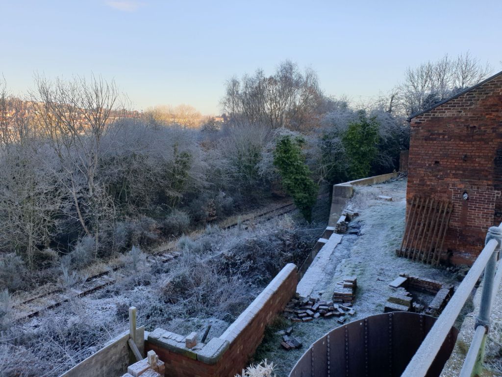 Snow-dusted winter landscape view over the railway line and canal towards Hemingfield from the rear of Hemingfield Colliery in early December 2023